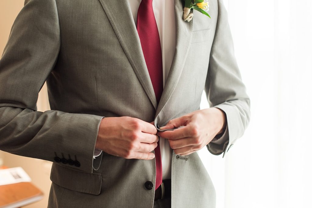 Groom getting ready in a grey suit