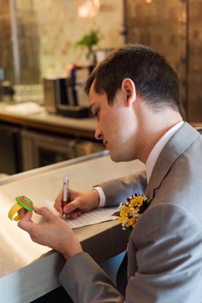 Groom reading letter from bride on wedding day