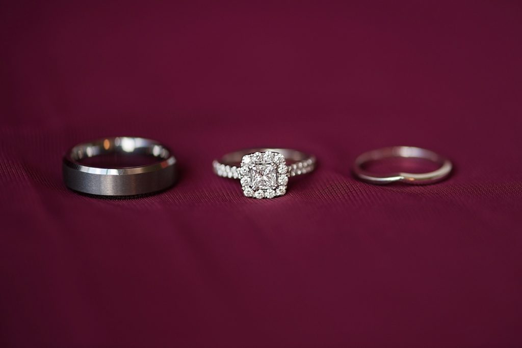 Wedding ring set on burgundy background