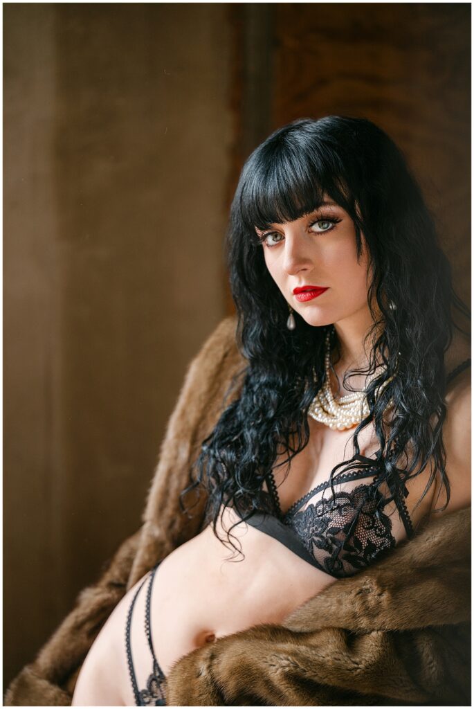 boudoir wears black lace lingerie and a luxurious fur wrap