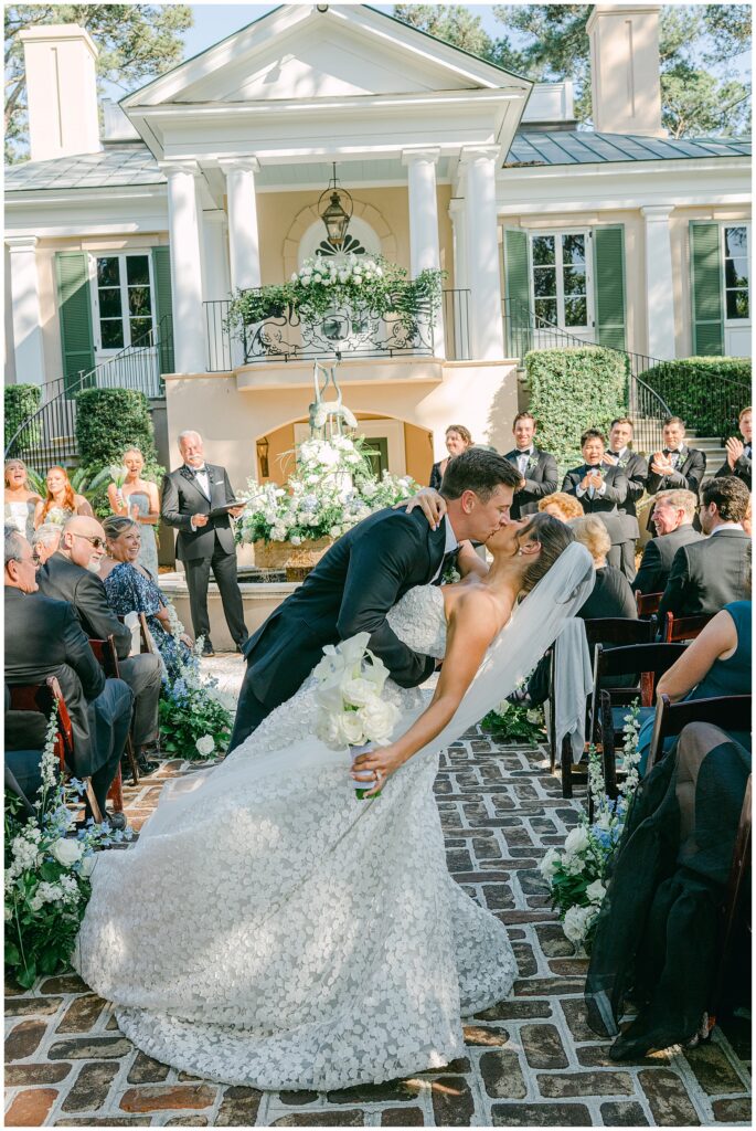 Bride and groom kissing at oldfield river club