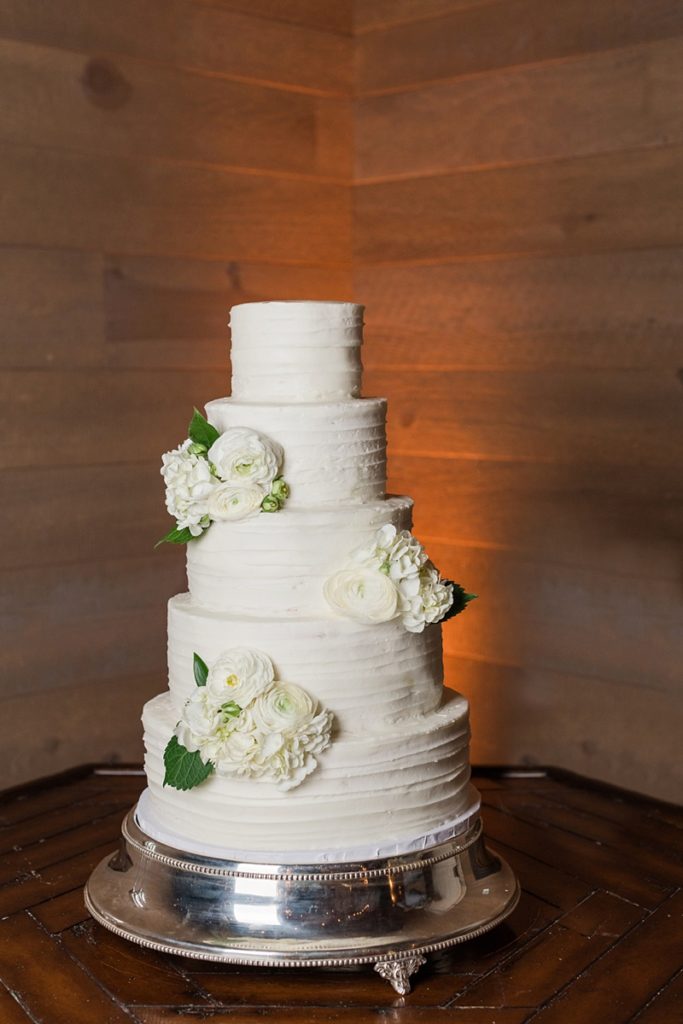 Gold and blush wedding reception details with classic white cake
