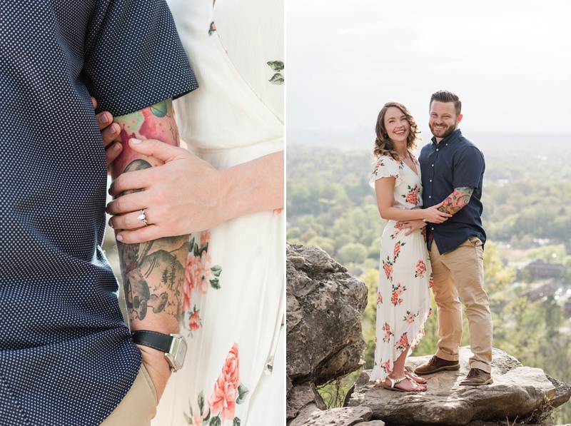 Groom with tattoos and bride with heirloom vintage engagement ring stand on cliff for engagement photos
