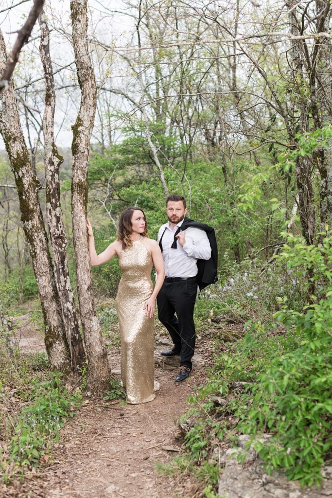Bride in rent the runway gold sequined dress for engagement session on a mountain