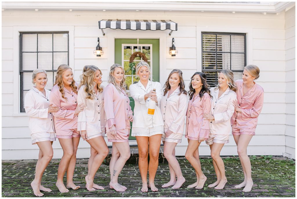 Bridal party popping champagne before getting ready
