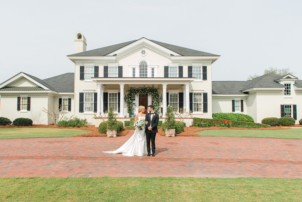 Bride and groom in front of her home
